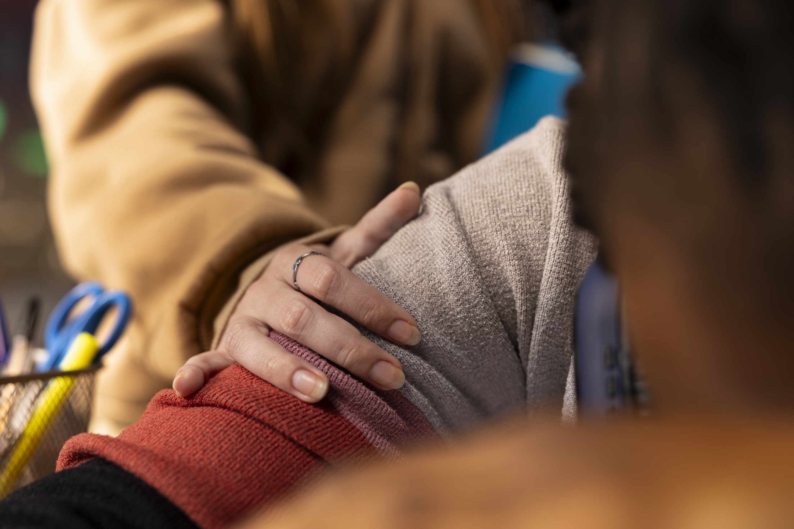 Young adult trying to wake up african american girl in the university library