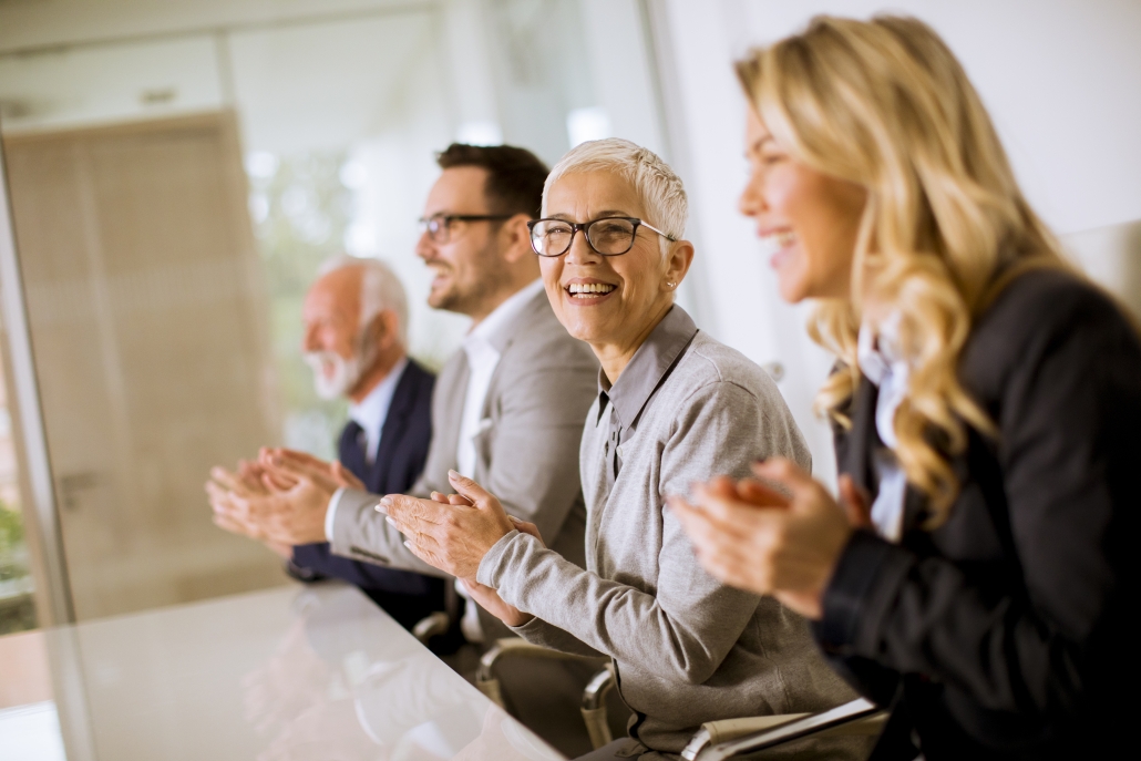 Satisfied proud business team clapping hands